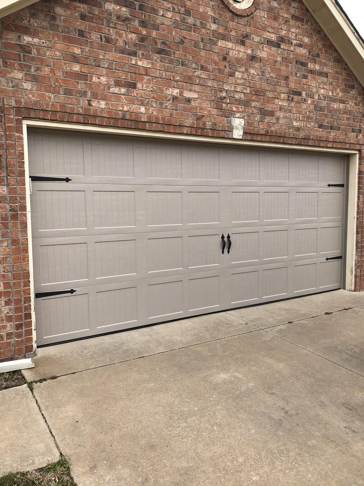 Carriage-style garage door on a brick home