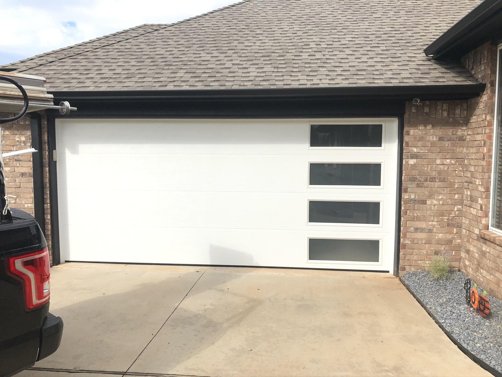 White contemporary garage door with vertical side windows